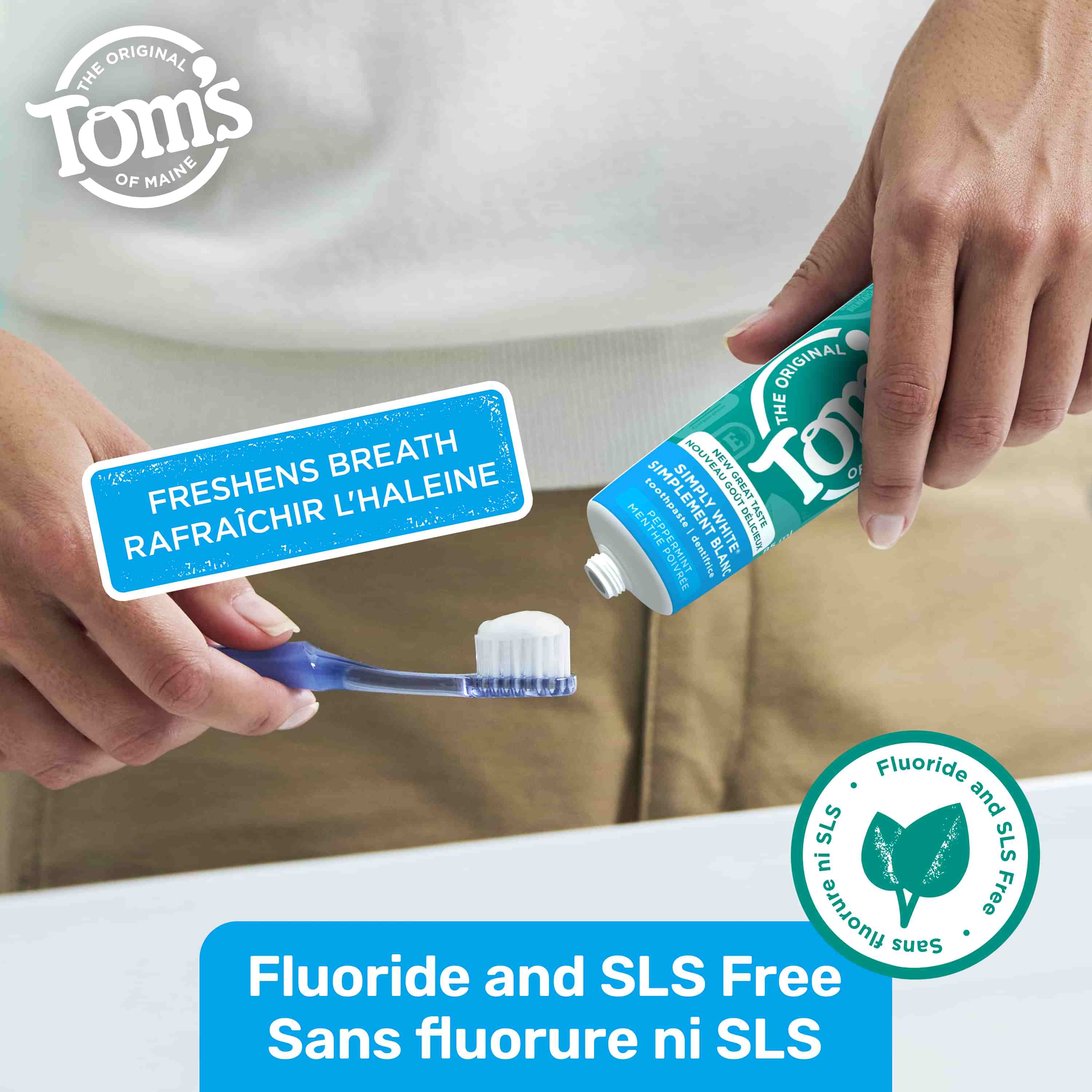 Close-up of hands squeezing Tom’s of Maine Simply White Fluoride Free Toothpaste, Peppermint onto a toothbrush with “Fluoride and SLS Free” message.