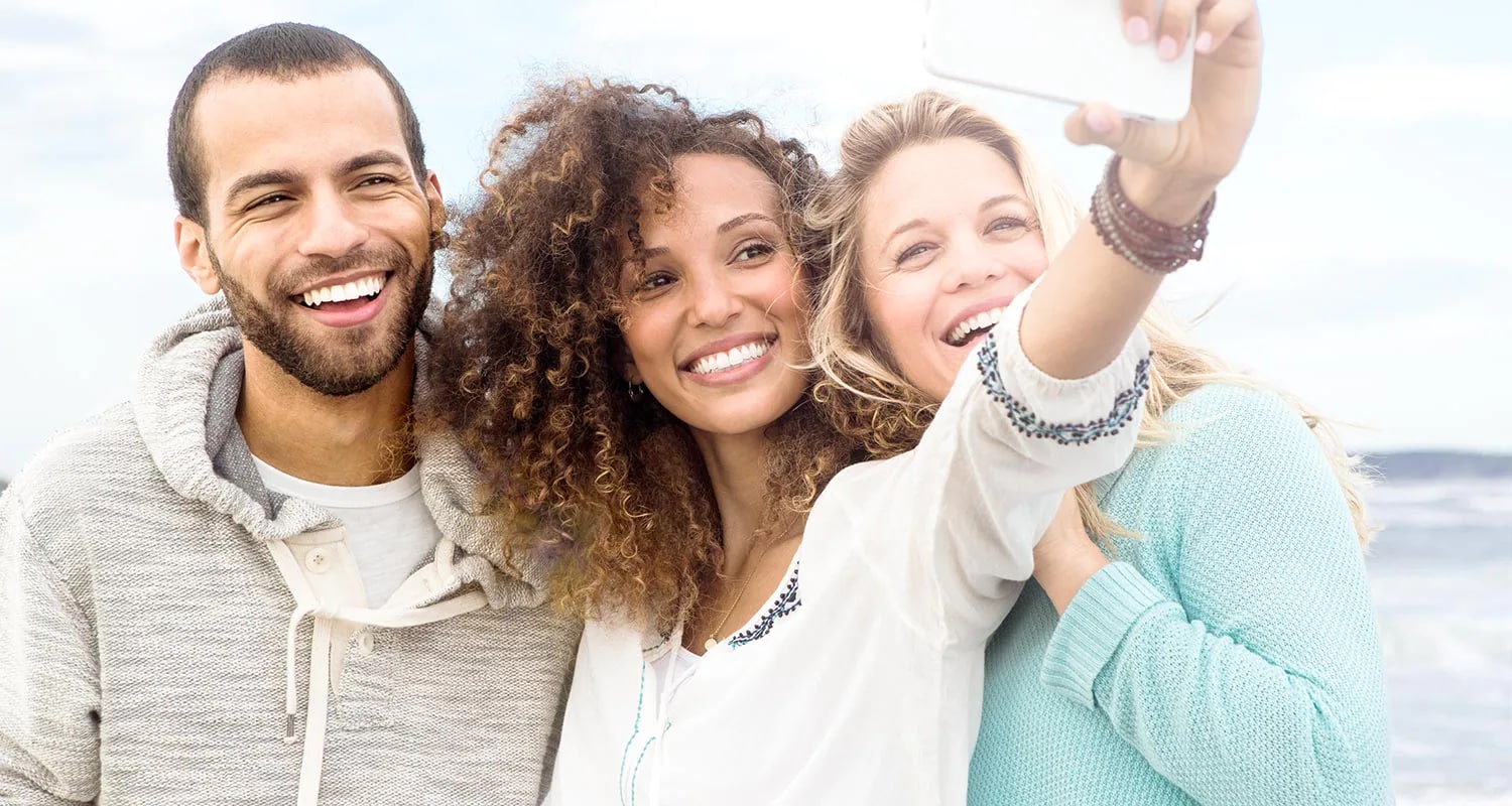 Three people taking selfie with a phone